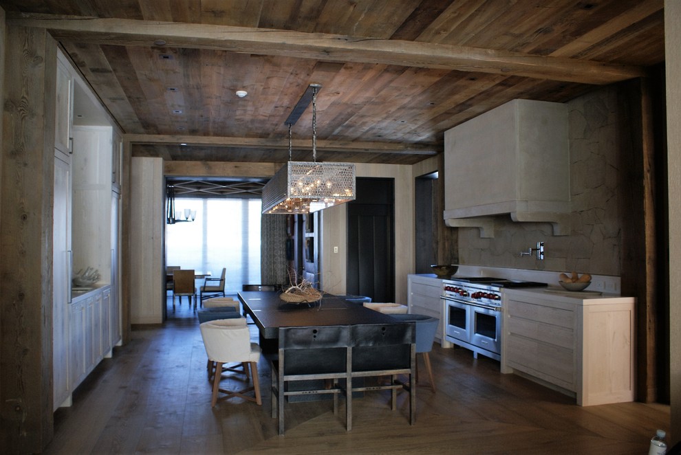 Example of a mid-sized mountain style dark wood floor kitchen/dining room combo design in Denver with brown walls and no fireplace