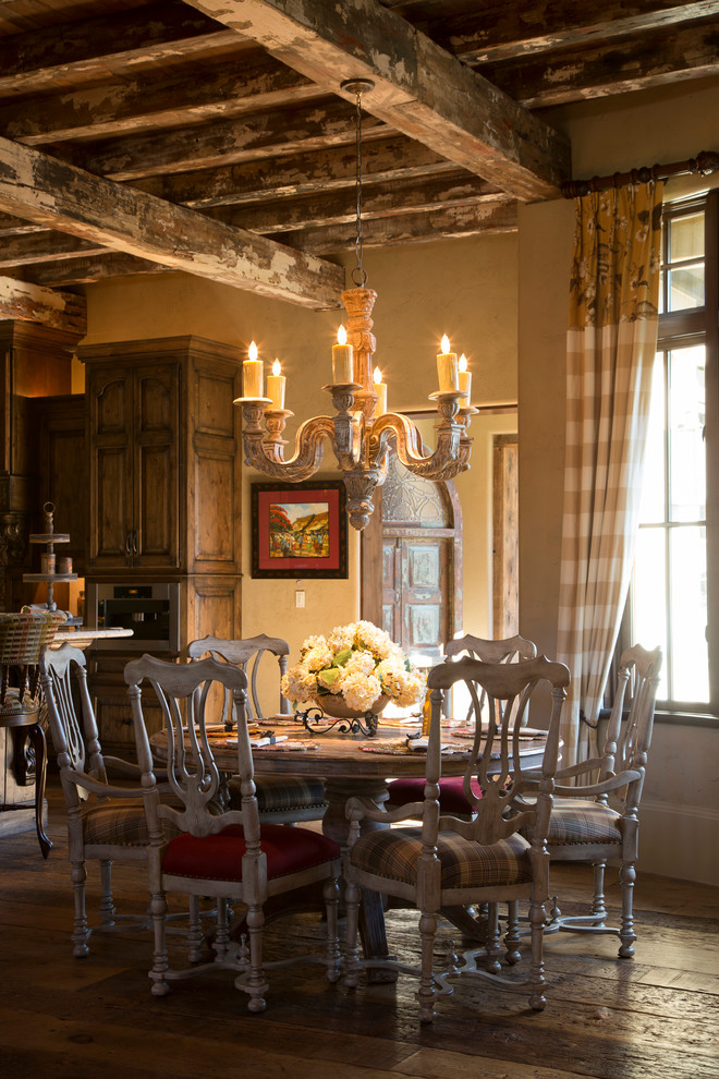 Inspiration for a large rustic kitchen/dining room in Houston with yellow walls.