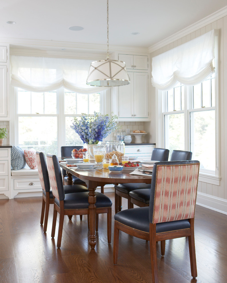 Example of a classic medium tone wood floor and brown floor dining room design in New York with beige walls