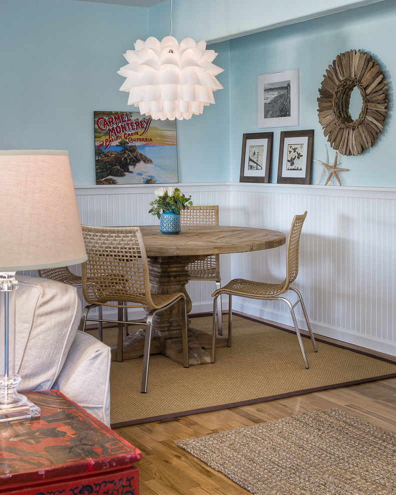 Coastal open plan dining room in San Luis Obispo with blue walls, medium hardwood flooring and feature lighting.