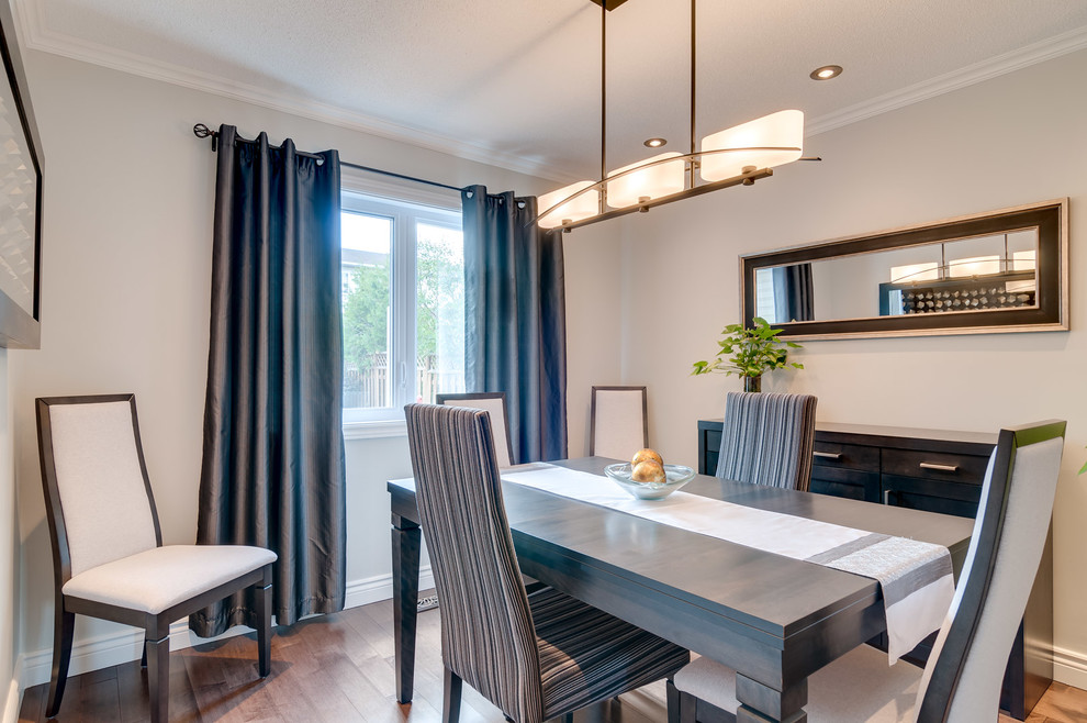 This is an example of a medium sized contemporary kitchen/dining room in Ottawa with grey walls, dark hardwood flooring and no fireplace.