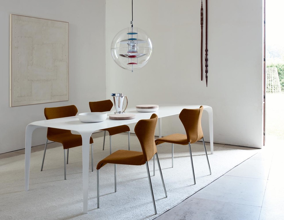 Contemporary dining room in Milan with white walls.