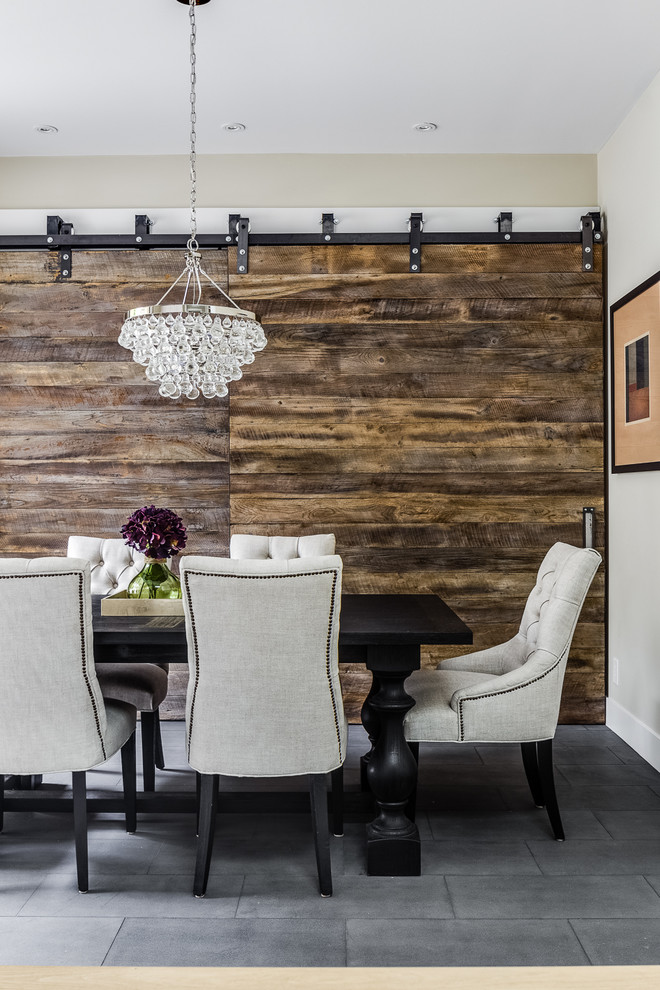 This is an example of a rustic enclosed dining room in San Francisco with beige walls, no fireplace and slate flooring.
