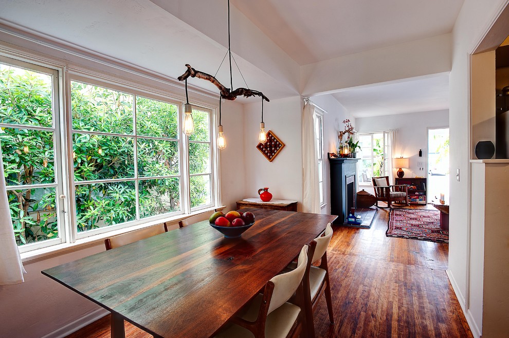 Inspiration for a rustic dark wood floor dining room remodel in Orange County with white walls