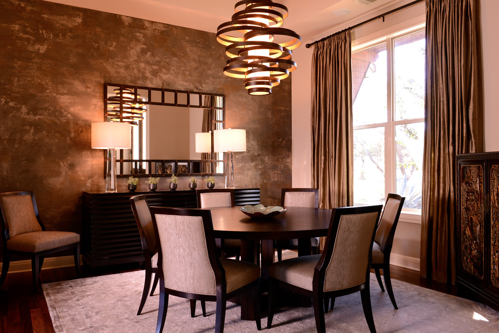 Design ideas for a contemporary dining room in Austin with white walls, dark hardwood flooring and feature lighting.