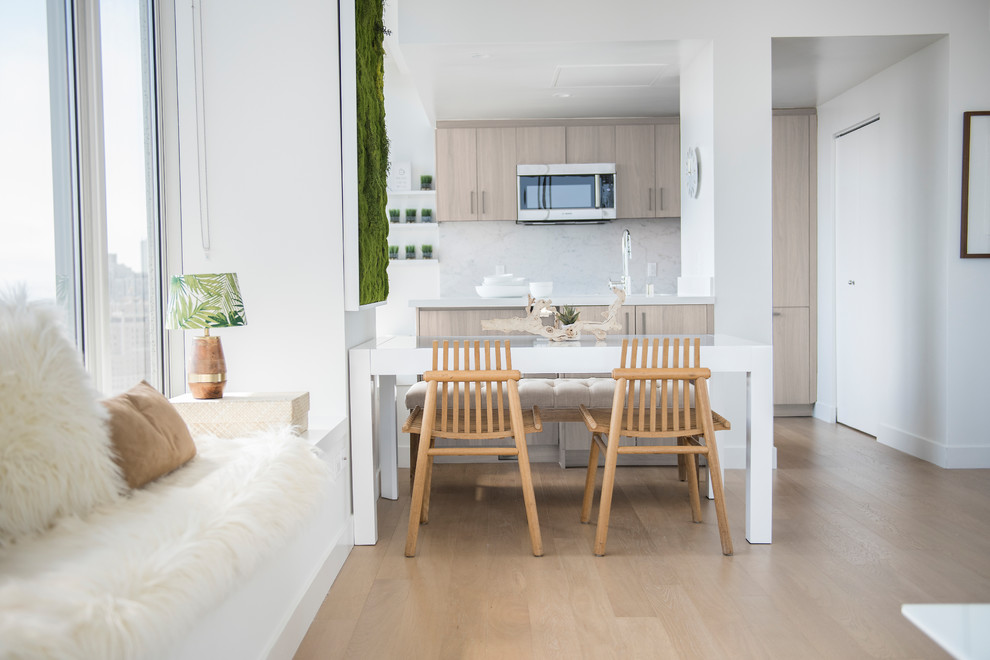 Ejemplo de comedor nórdico pequeño abierto sin chimenea con paredes blancas, suelo de madera clara y suelo beige