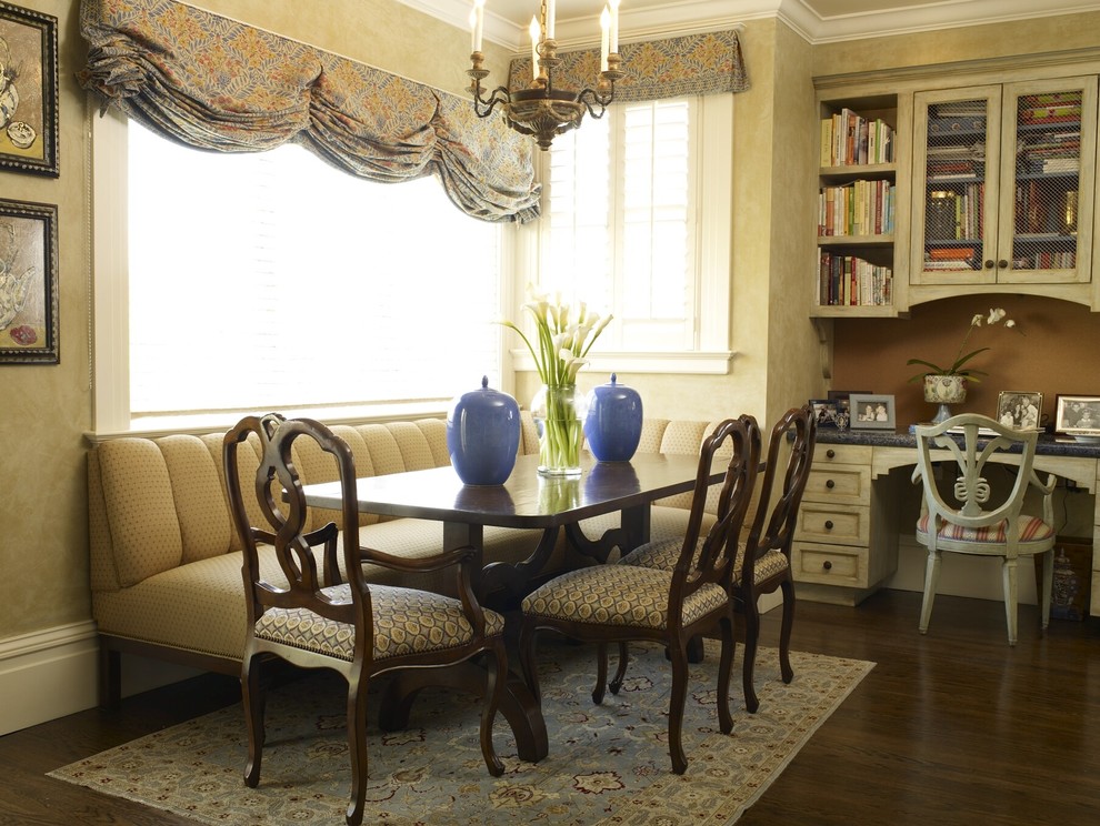 This is an example of a classic dining room in San Francisco with beige walls and dark hardwood flooring.