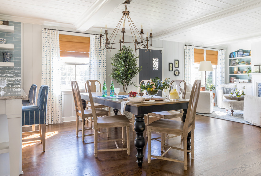 Farmhouse dining room in Jacksonville with grey walls, medium hardwood flooring, brown floors and feature lighting.