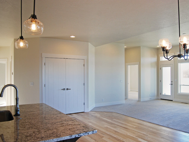 Great room - mid-sized transitional light wood floor great room idea in Boise with white walls