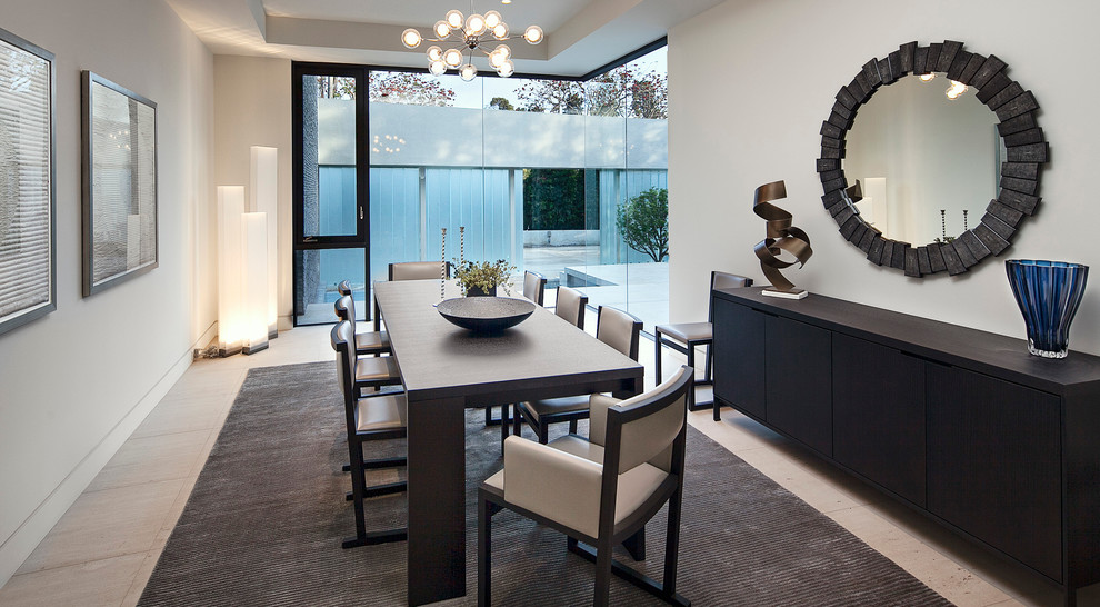 This is an example of a contemporary dining room in Los Angeles with white walls and no fireplace.