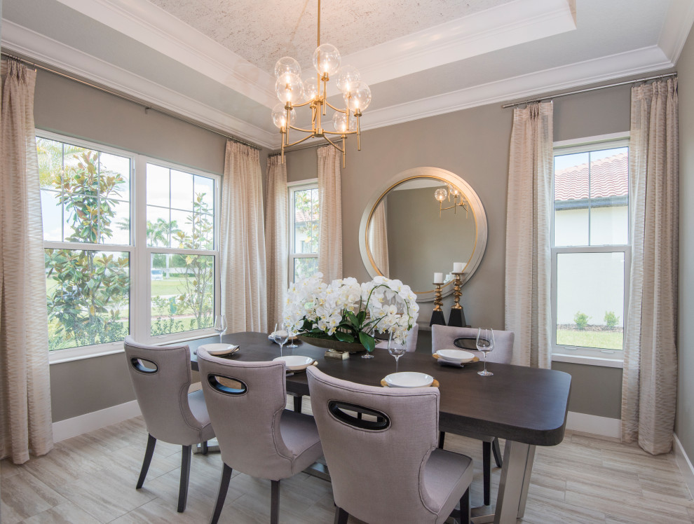 Traditional enclosed dining room in Tampa with beige walls, medium hardwood flooring, no fireplace, brown floors, a vaulted ceiling and a wallpapered ceiling.