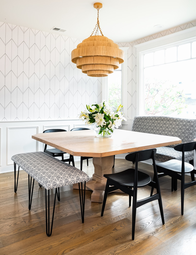 Design ideas for a medium sized nautical dining room in Los Angeles with banquette seating, white walls, light hardwood flooring, brown floors and wallpapered walls.