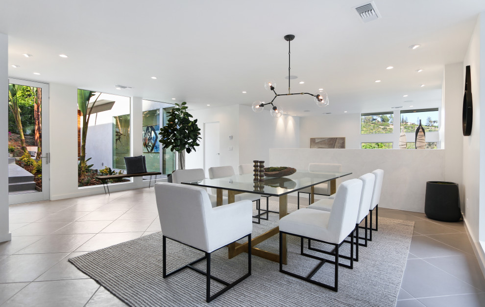 Inspiration for a medium sized midcentury kitchen/dining room in Los Angeles with white walls, porcelain flooring and grey floors.