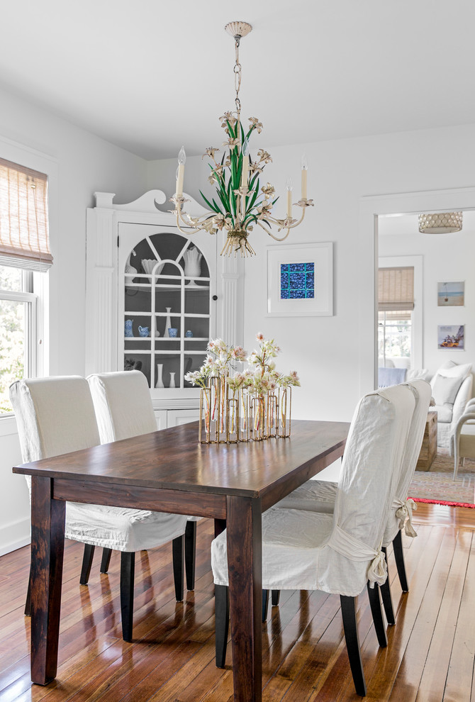 Design ideas for a small coastal enclosed dining room in Boston with white walls, medium hardwood flooring and no fireplace.