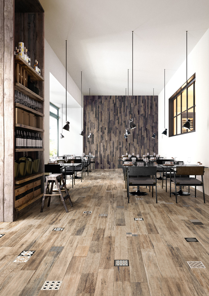 This is an example of a rustic open plan dining room in San Francisco with white walls and porcelain flooring.