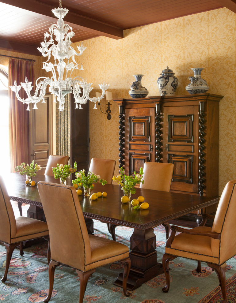 Medium sized mediterranean open plan dining room in Los Angeles with yellow walls and dark hardwood flooring.