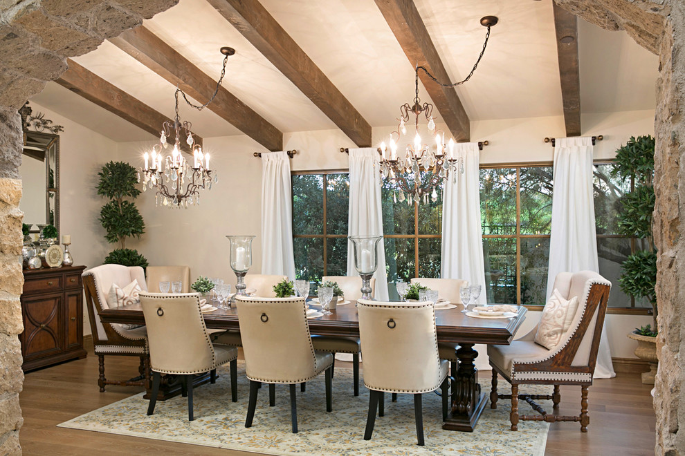 Dining room - mediterranean light wood floor and beige floor dining room idea in San Diego with white walls