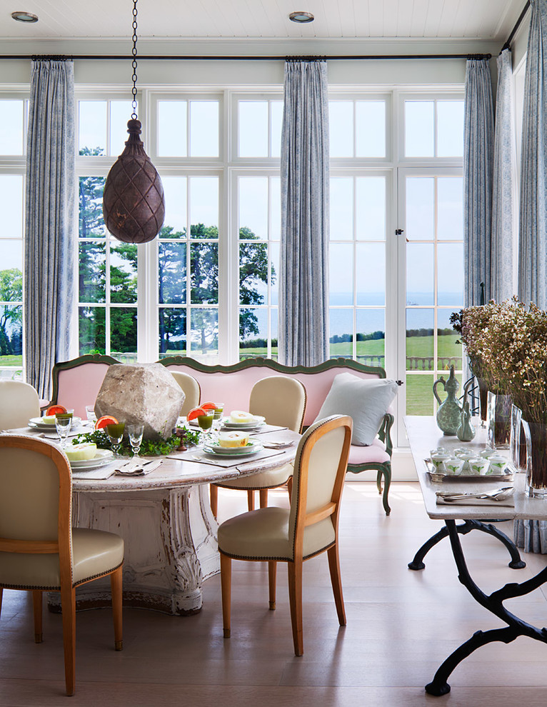 This is an example of a classic dining room in New York with white walls, dark hardwood flooring and brown floors.