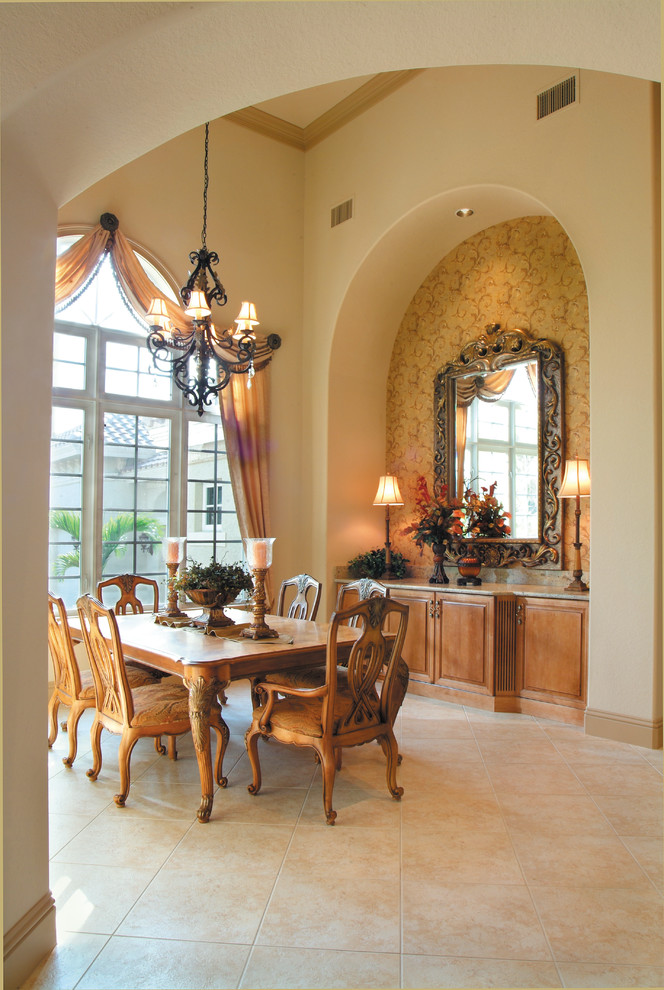 Large tuscan ceramic tile enclosed dining room photo in Miami with beige walls and no fireplace