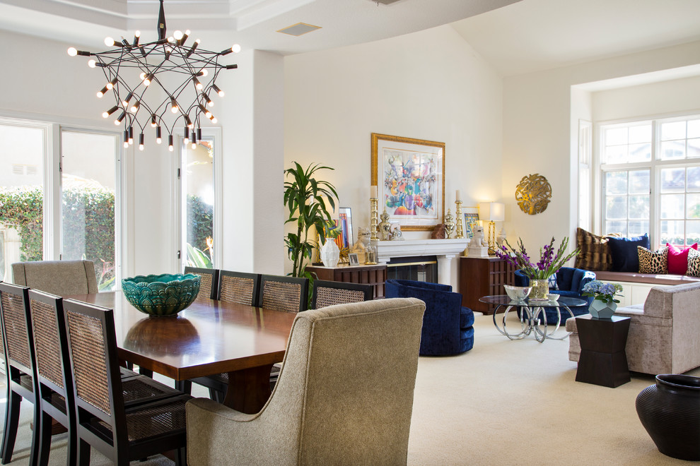 This is an example of a medium sized eclectic open plan dining room in San Diego with white walls, carpet and white floors.