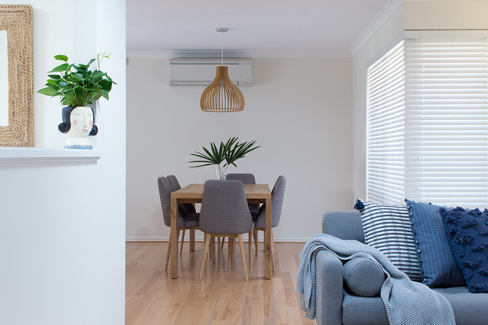 This is an example of a small scandinavian dining room in Perth with white walls and light hardwood flooring.