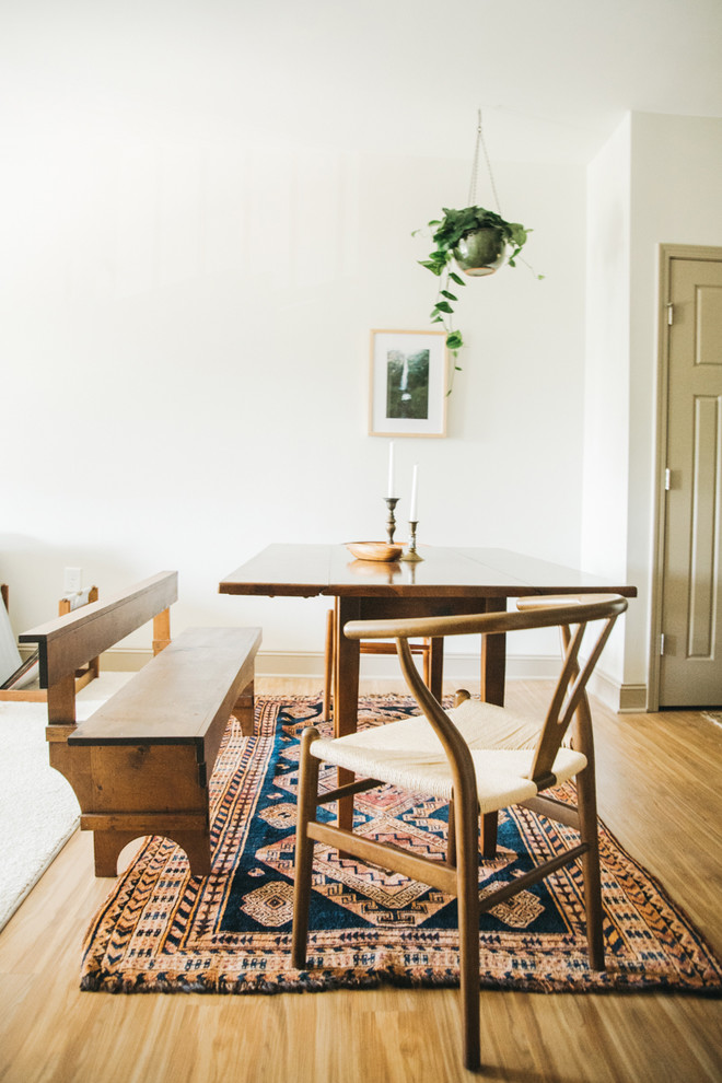 Photo of a scandinavian dining room in Other with white walls, light hardwood flooring and brown floors.