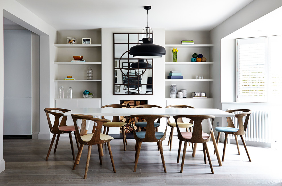 Design ideas for a scandinavian dining room in London with white walls and medium hardwood flooring.