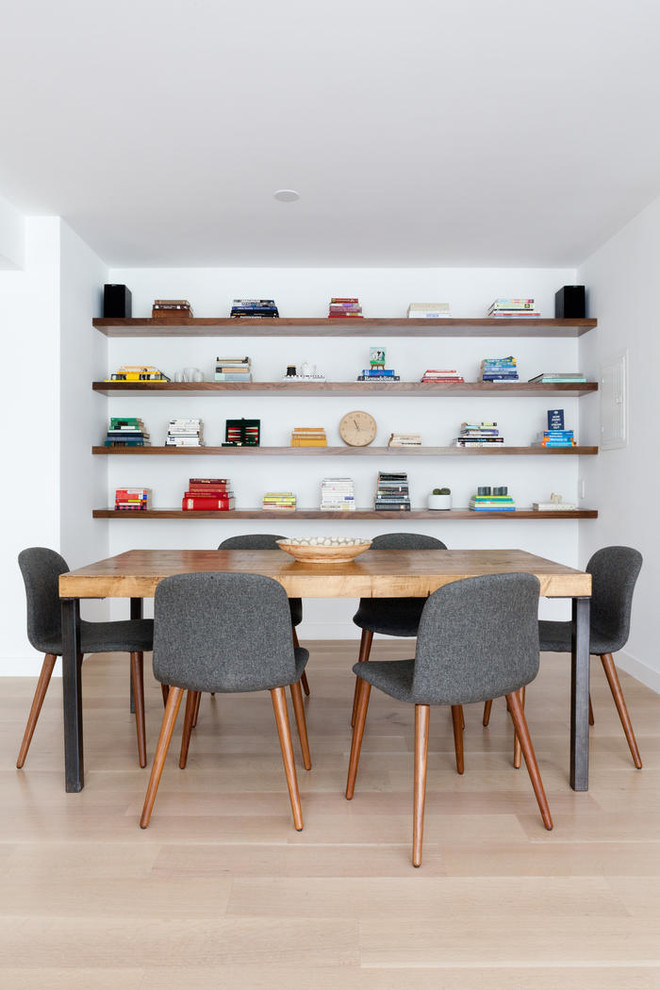 Large danish light wood floor dining room photo in Los Angeles with white walls