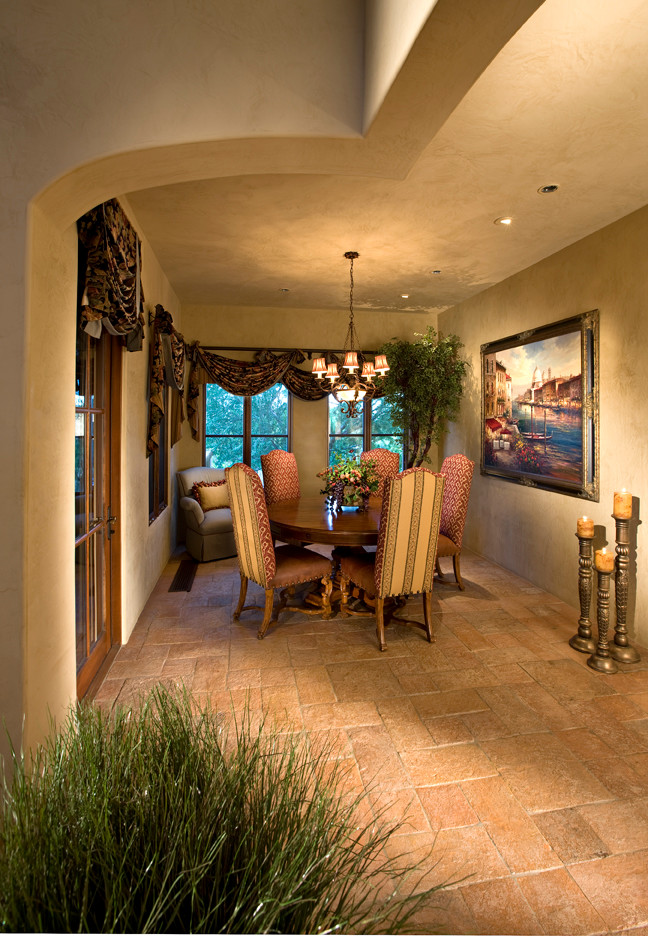 Mid-sized tuscan medium tone wood floor enclosed dining room photo in Phoenix with beige walls