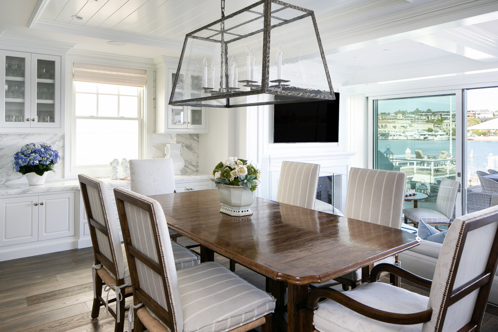 Beach style dark wood floor, brown floor, shiplap ceiling and tray ceiling dining room photo in Orange County with white walls