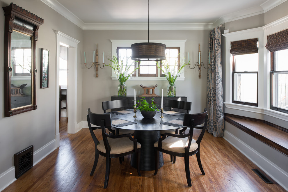 Inspiration for a timeless medium tone wood floor enclosed dining room remodel in Minneapolis with gray walls