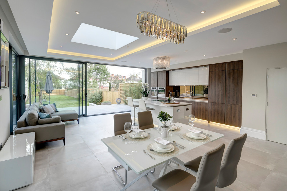 Inspiration for a large contemporary open plan dining room in London with grey floors and beige walls.