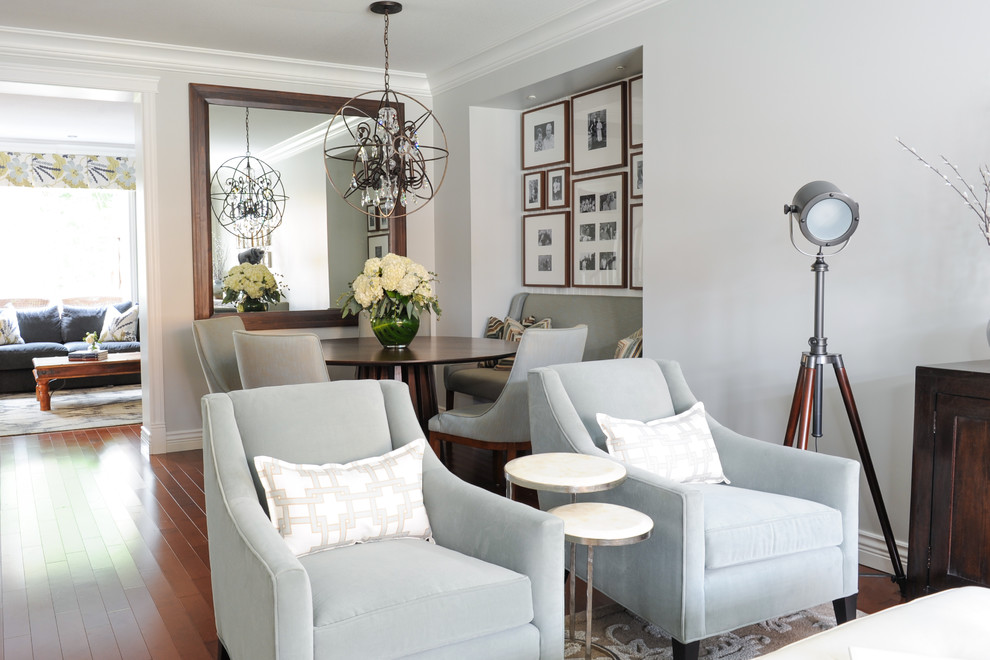 Example of a small transitional medium tone wood floor enclosed dining room design in Vancouver with gray walls