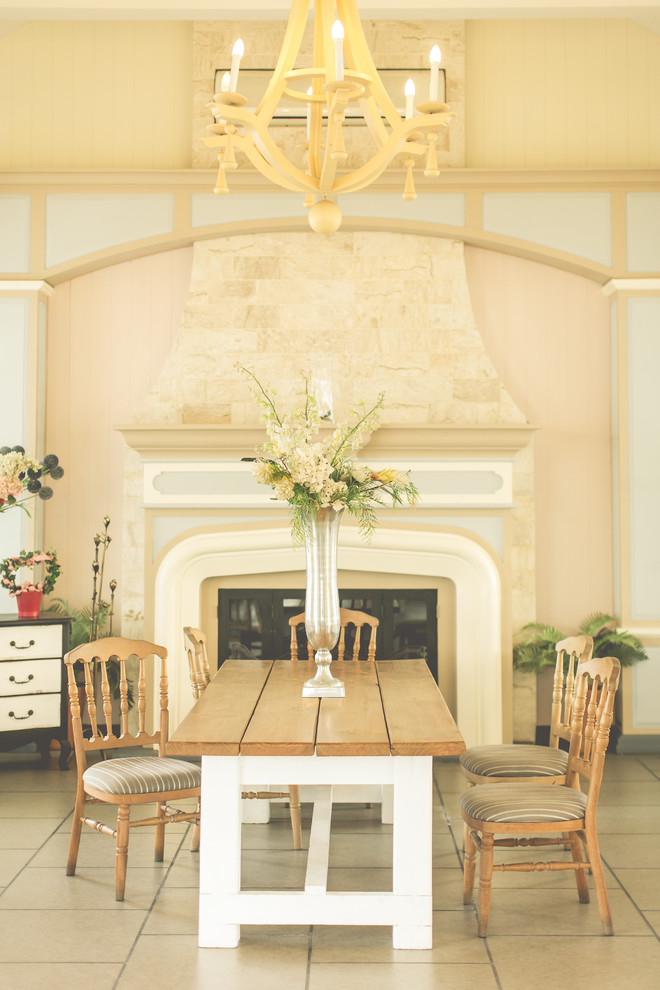 Réalisation d'une grande salle à manger ouverte sur la cuisine style shabby chic avec un mur beige, un sol en carrelage de céramique, une cheminée standard, un manteau de cheminée en bois et un sol beige.