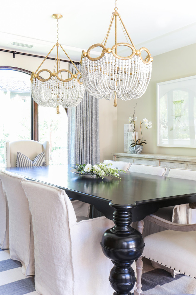Example of a large transitional dark wood floor enclosed dining room design in Orange County with white walls