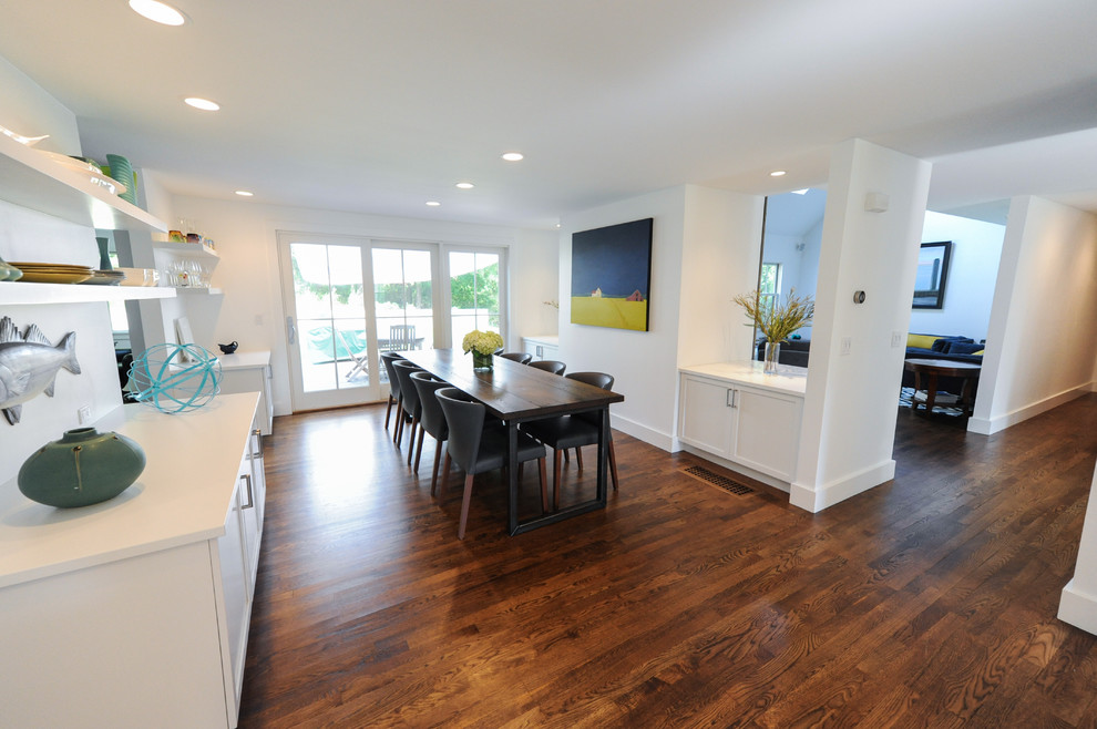 This is an example of a small classic kitchen/dining room in Boston with white walls and dark hardwood flooring.