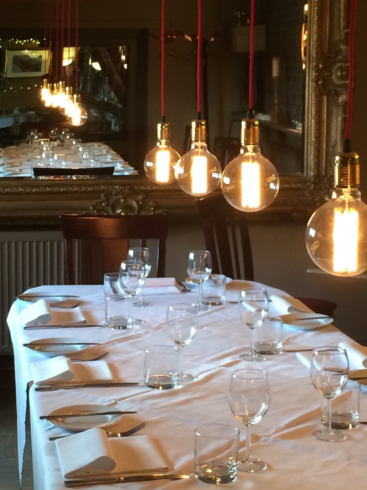 Photo of a medium sized industrial dining room in London.