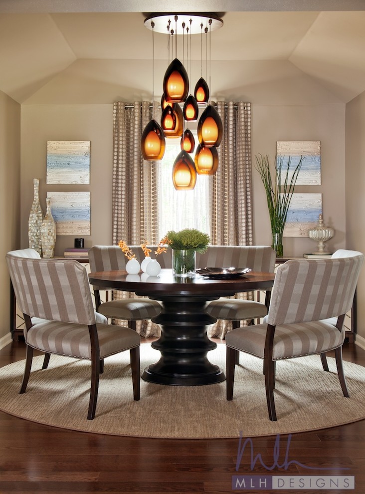 Inspiration for a large timeless medium tone wood floor enclosed dining room remodel in Little Rock with beige walls