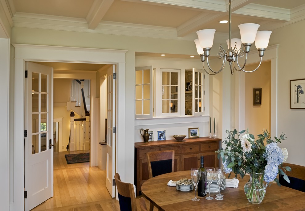 Ornate medium tone wood floor dining room photo in Burlington with beige walls