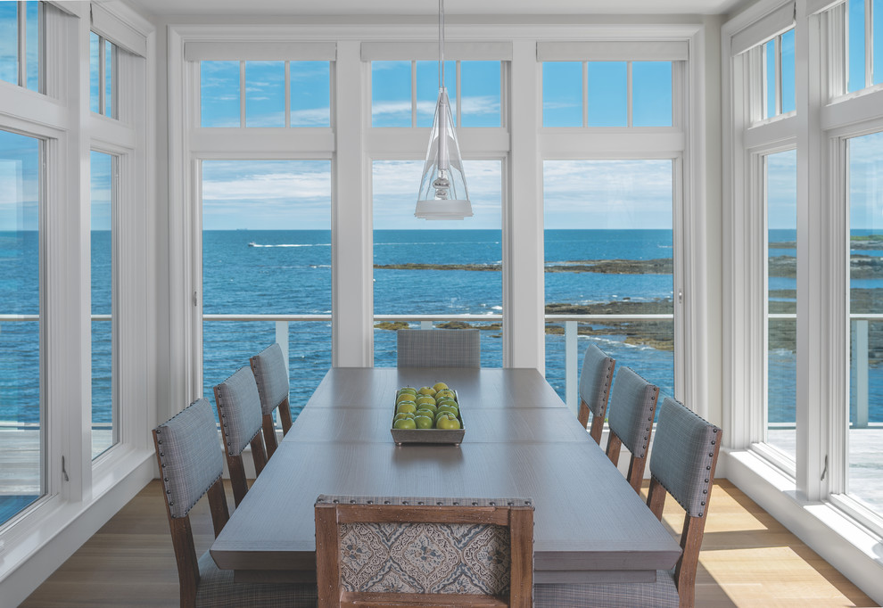 Medium sized coastal enclosed dining room in Portland Maine with white walls, light hardwood flooring, no fireplace and brown floors.