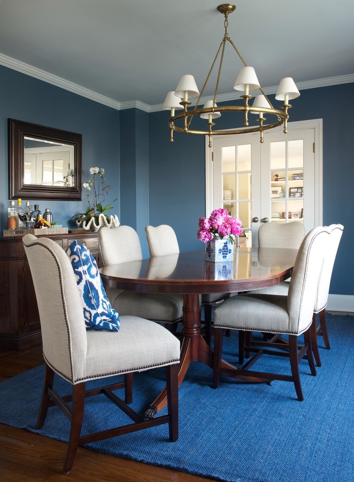 Inspiration for a traditional enclosed dining room in New York with blue walls.
