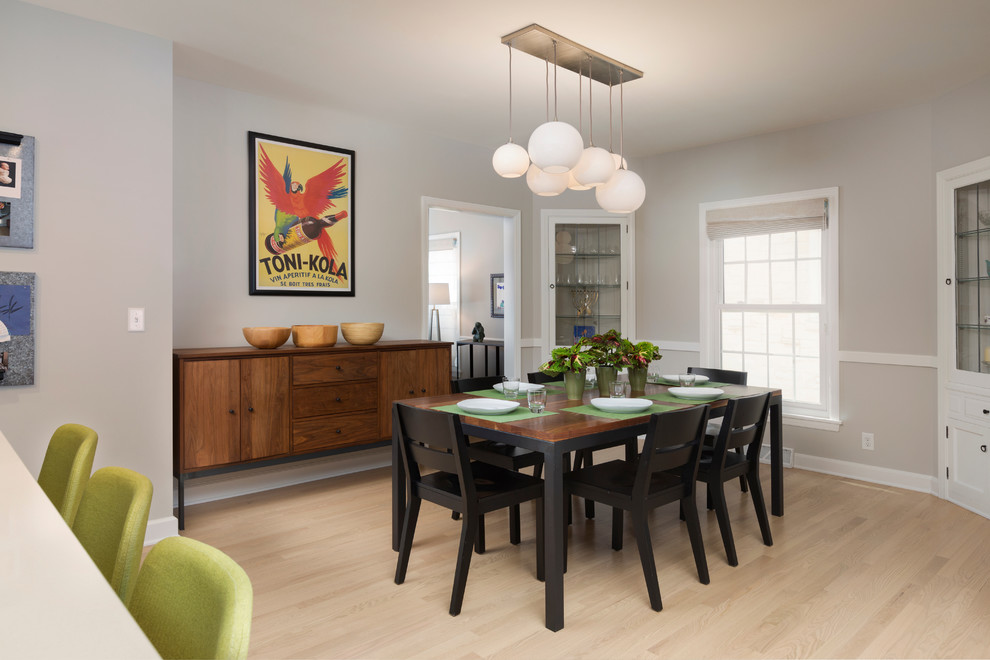 This is an example of a medium sized contemporary kitchen/dining room in Milwaukee with grey walls and light hardwood flooring.