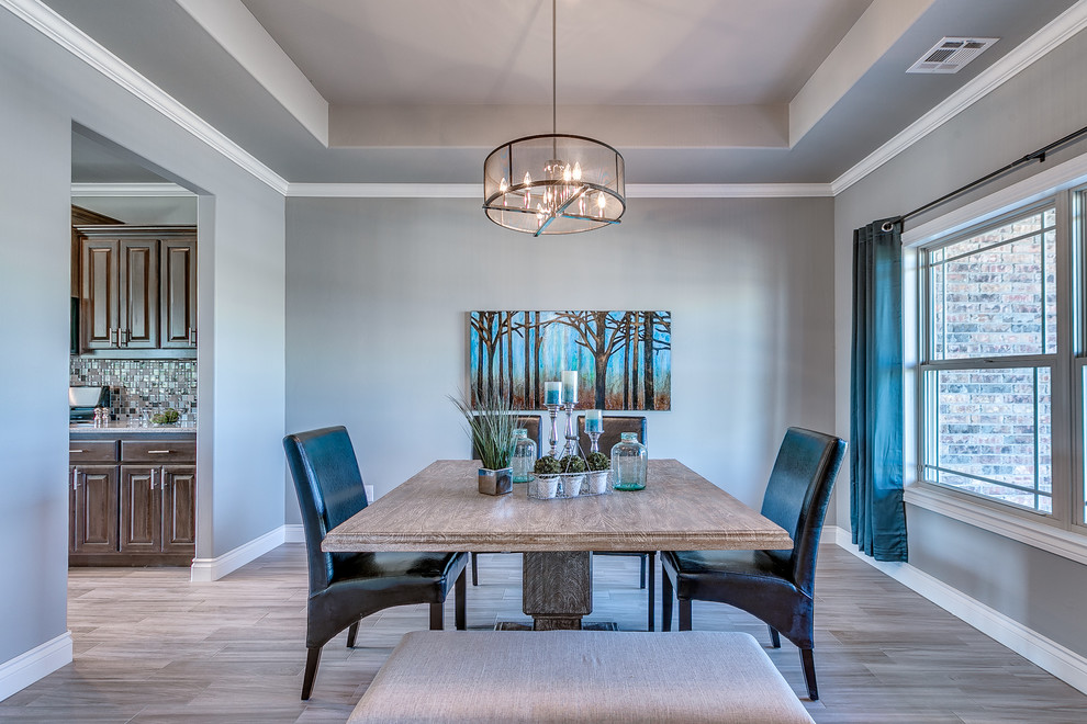 This is an example of a contemporary dining room in Oklahoma City with grey walls.