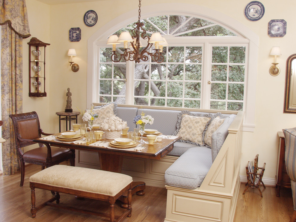 This is an example of a classic dining room in Los Angeles with beige walls and medium hardwood flooring.