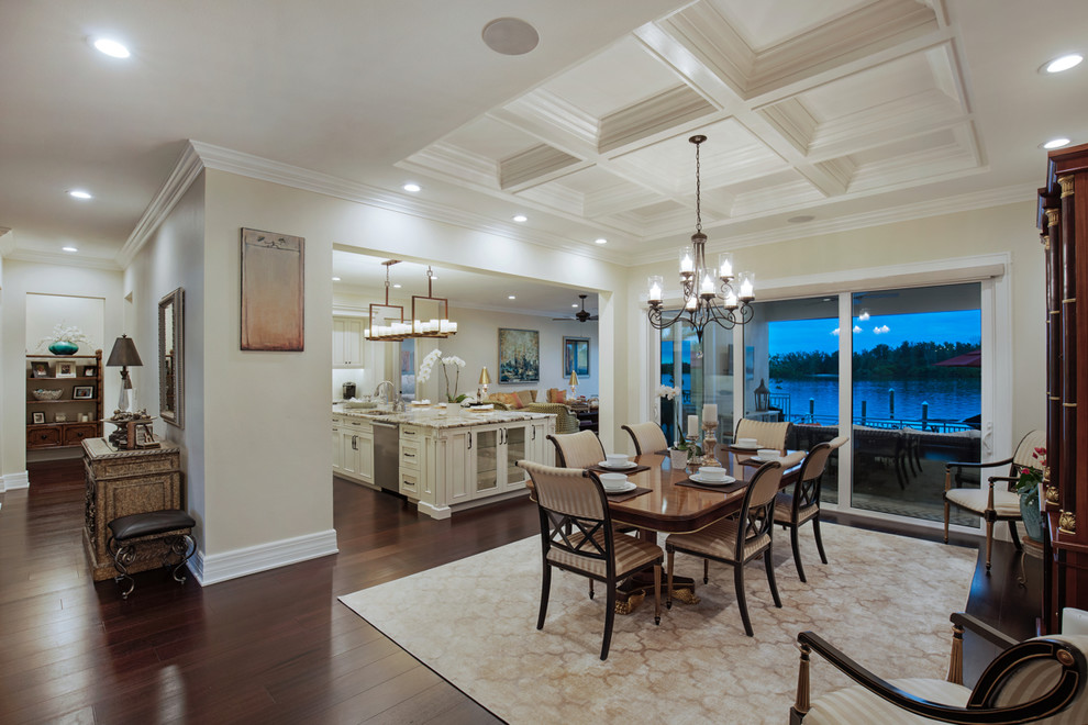 Example of a large transitional dark wood floor and brown floor kitchen/dining room combo design in Tampa with beige walls and no fireplace