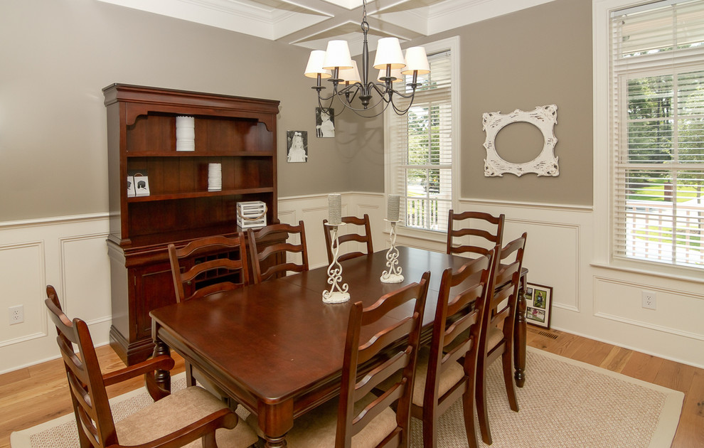 Enclosed dining room - mid-sized traditional medium tone wood floor enclosed dining room idea in Charleston with gray walls