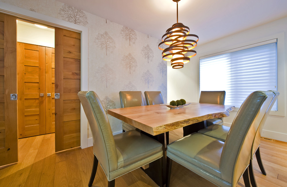 Trendy medium tone wood floor dining room photo in Calgary with white walls