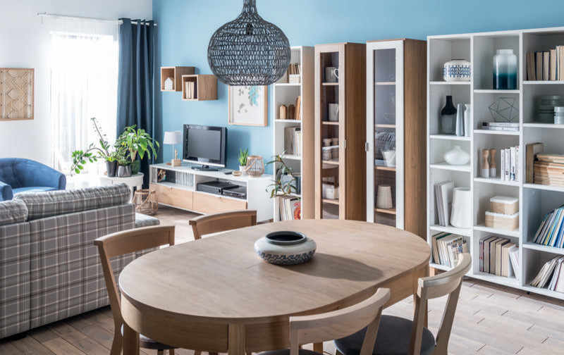 This is an example of a medium sized scandinavian open plan dining room in Toronto with blue walls, laminate floors, no fireplace and beige floors.