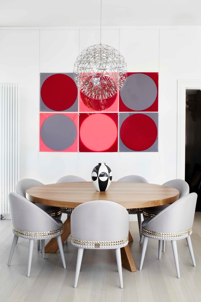 Example of a trendy light wood floor dining room design in Melbourne with white walls