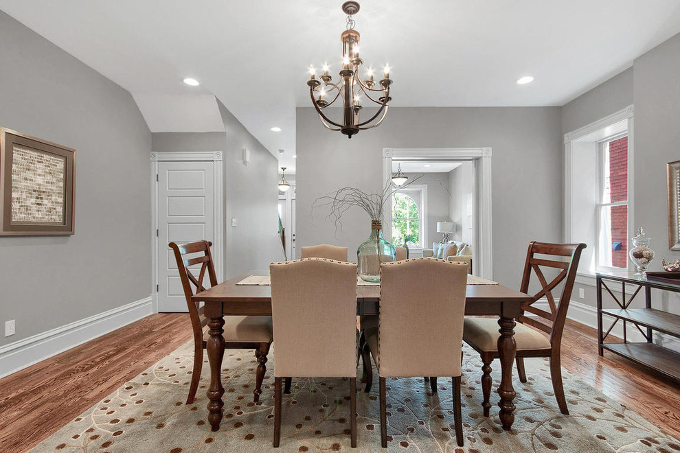 Mid-sized transitional dark wood floor and brown floor enclosed dining room photo in St Louis with gray walls and no fireplace